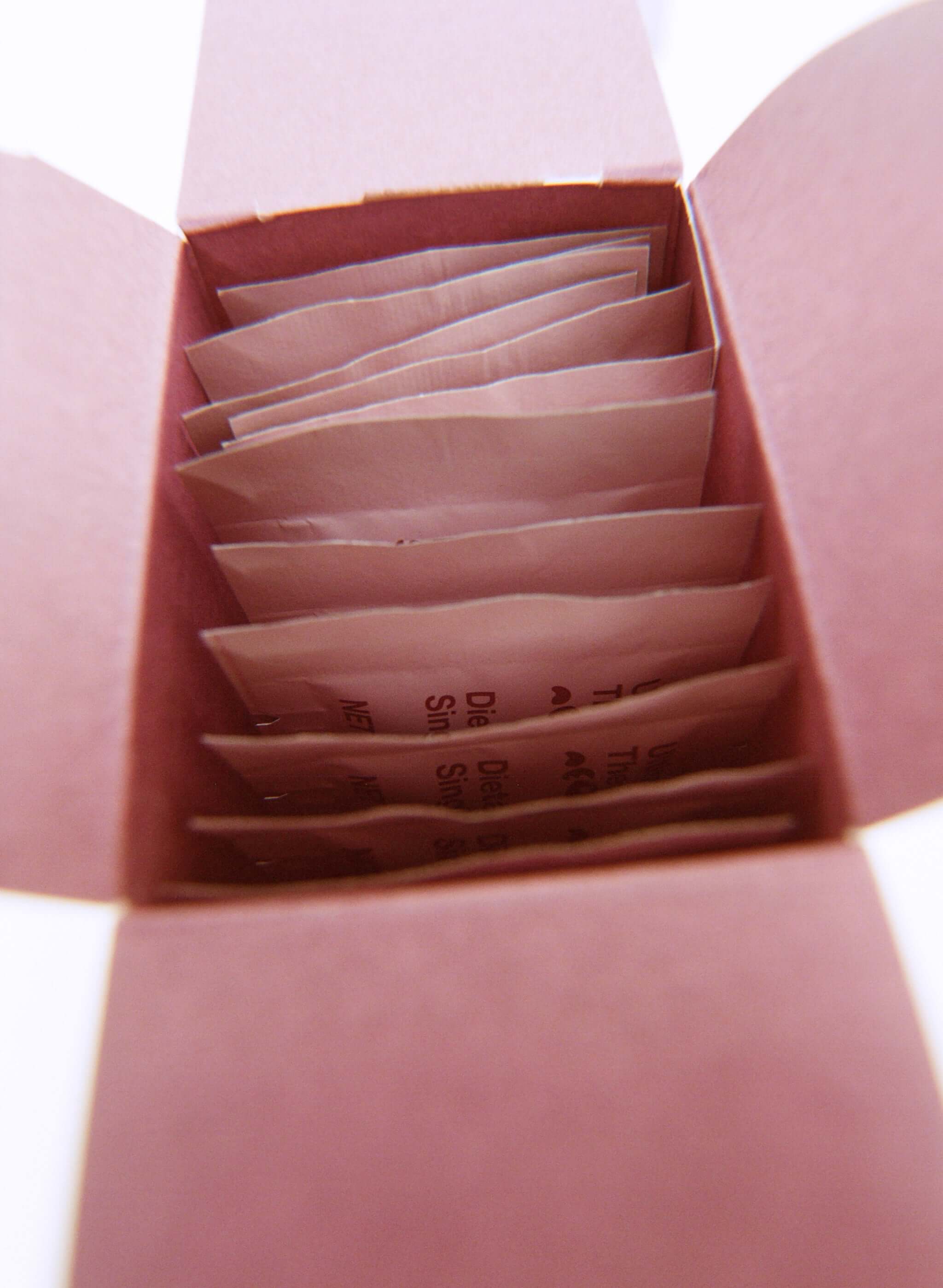 Inside view of a pink box containing individual packets of neoNutritions® Ultimate Beauty collagen boosting beauty supplement.