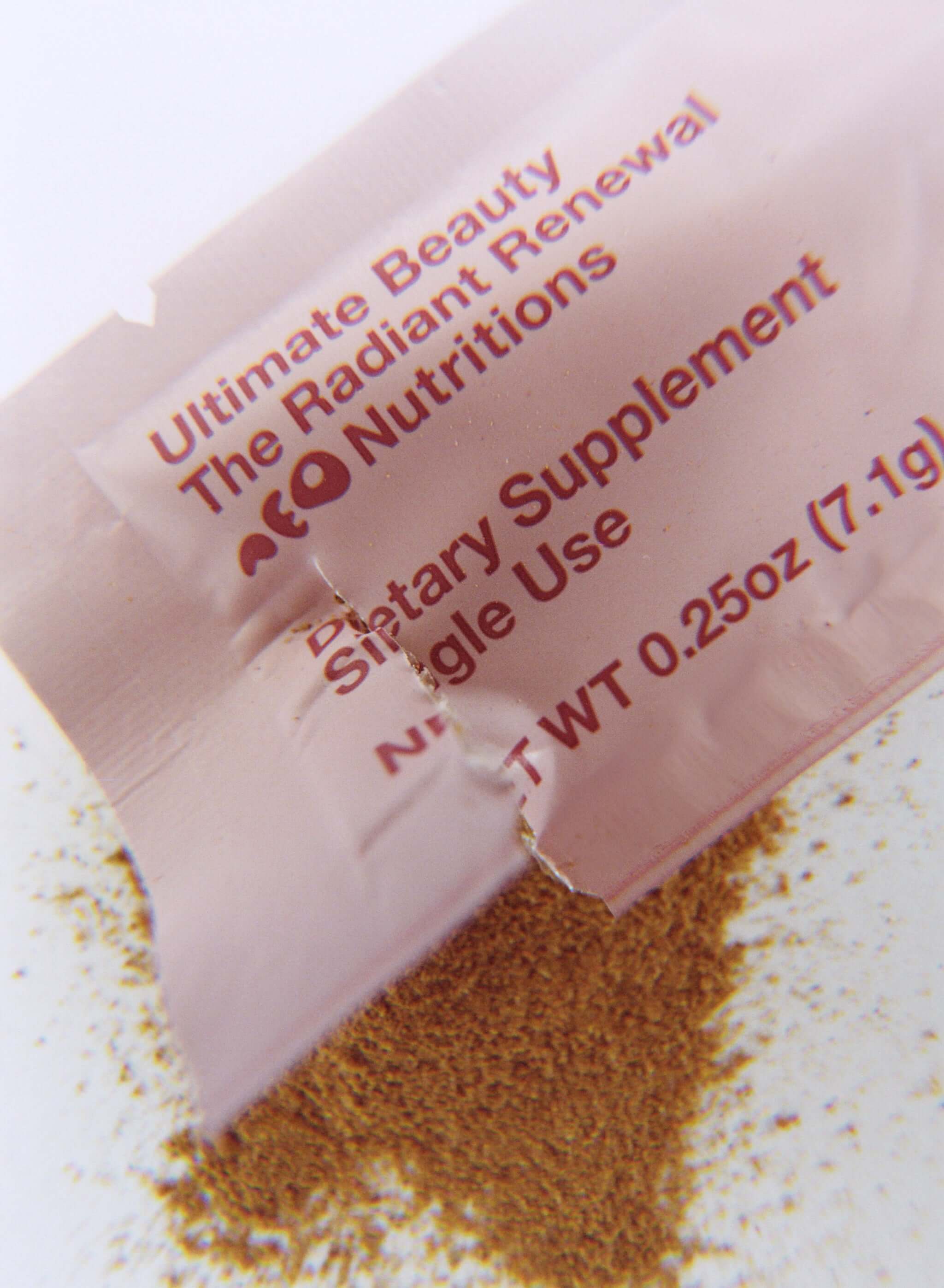 neoNutritions® Ultimate Beauty organic collagen boosting beauty supplement powder in packaging with scattered powder.